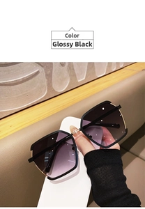 Detail of half-frame sunglasses with gold metal accents and purple gradient lenses