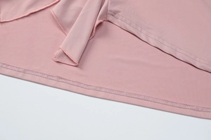 Close-up of pink dress fabric showing professional double-needle stitching and knit texture