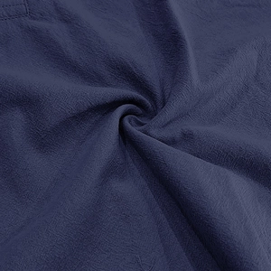 Close-up of deep navy linen fabric texture showing breathable cotton blend weave