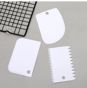 Three-piece set of white food-grade plastic dough scrapers and cake texture spatulas
