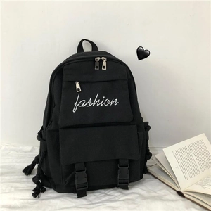 Detail of fashion embroidery on black canvas backpack with multi-pocket design