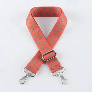 Detail of adjustable woven canvas strap with orange and grey geometric fishbone pattern