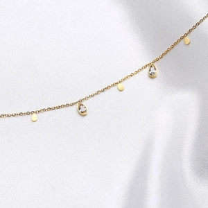 Detail of titanium gold O-chain necklace with sparkling waterdrop zircon pendants