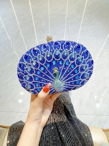 Detailed macro view of a luxury blue peacock evening bag with sparkling rhinestones