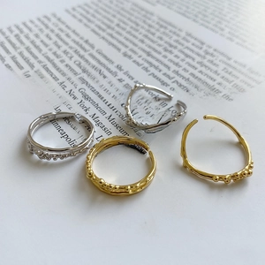 Detailed shot of irregular bubble texture and S925 hallmark on stacked silver rings