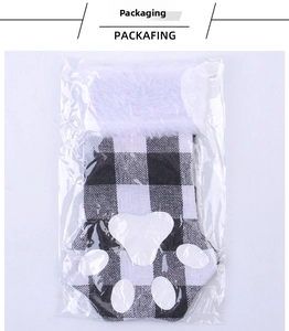 Close-up of a black and white plaid cat paw Christmas stocking wrapped in plastic bag