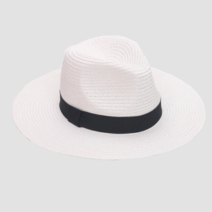 Detailed top view of white straw sun hat with black ribbon decoration and woven texture