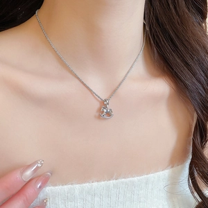 Close-up of silver rocking horse pendant necklace with sparkling pavé cubic zirconia