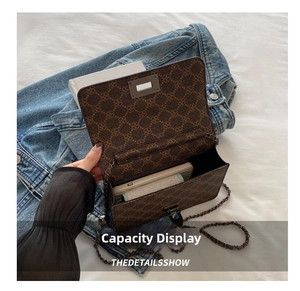 Detail view of the brown vintage chain bag interior showing smartphone storage capacity