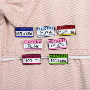 Detail shot of K-pop enamel pins featuring ARMY, BLINK, and ONCE fandom names on denim