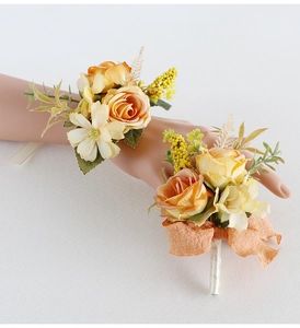 Detail of vintage champagne rose boutonniere and wrist corsage set with silk ribbons
