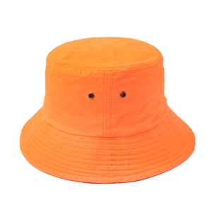 Detail of orange canvas bucket hat featuring metal eyelets and reinforced stitched brim