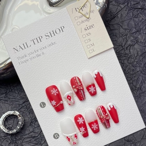 Handmade Christmas press-on nails set with red snowflakes and golden bow accents
