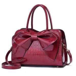 Fashionable wine red crossbody bag with a large bow and glossy crocodile pattern texture