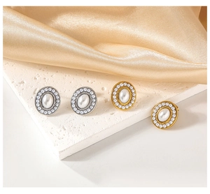 Detailed view of vintage oval earrings in gold and silver finish with inlaid pearls