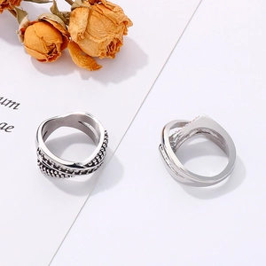 Detail of silver woven ring showing multi-layer cross design and 925 hallmark