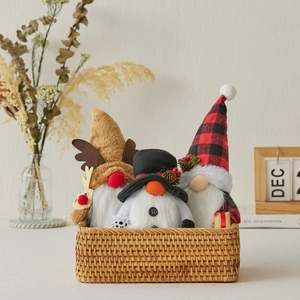 Three festive Christmas gnomes in a woven basket with reindeer and plaid hat designs