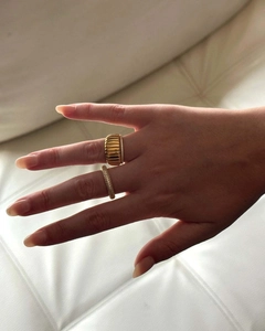 Detail of 18k gold vintage croissant ring and pavé zircon band on a model finger
