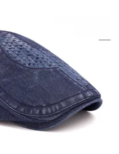 Detail of blue denim ivy cap featuring quilted stitching and a foldable long brim