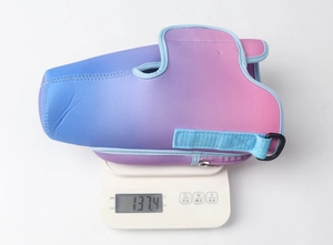 Detail of gradient neoprene water bottle pouch with strap and D-ring on digital scale