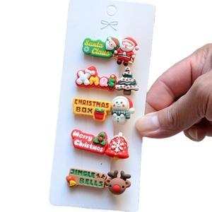 Close-up of five-piece Christmas hair clip set with Santa and reindeer on display card