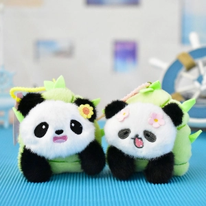 Detailed view of two cute panda plush keychains tucked inside green bamboo shoots