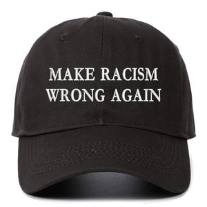 Detailed close-up of white embroidery text on a black washed cotton baseball cap
