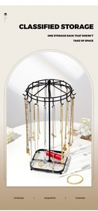 Close-up of black metal jewelry organizer with hooks and square base for necklaces