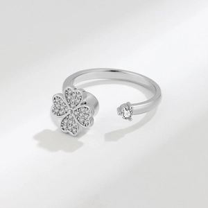 Rotating silver four-leaf clover ring with sparkling zircon in an adjustable open design
