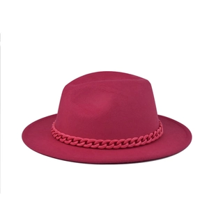 Detail of rose red wool felt flat top hat with chunky matching plastic chain band