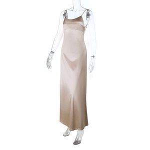 Detail of champagne satin slip dress fabric texture and long silhouette on a clear form