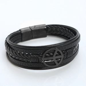 Detail of multilayer black braided leather bracelet with matte black peace sign charm