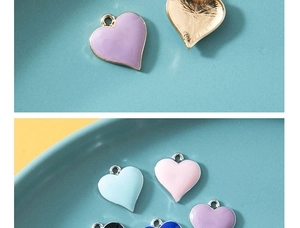 Macro view of multi-color enamel heart charms in purple, blue and pink alloy