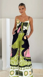 Detail of artistic print sleeveless jumpsuit with lace-up chest and wide leg cut