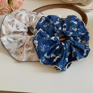 Detail of floral scrunchies with rabbit and lavender patterns on a wooden tray