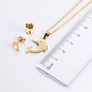 Detailed view of gold dolphin jewelry set with ruler for scale measurements