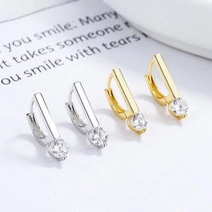 Detail of 925 sterling silver geometric drop earrings with round-cut sparkling stones
