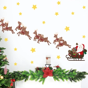 Christmas wall decal set featuring Santa Claus in sleigh with flying reindeer and stars