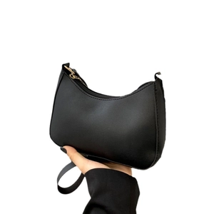 Minimalist black crescent hobo shoulder bag in matte faux leather with top zipper