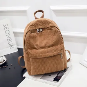 Brown corduroy backpack with large main compartment and vintage college style design