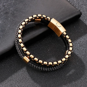 Detail of multi-layer leather bracelet with gold-tone beads and magnetic steel clasp