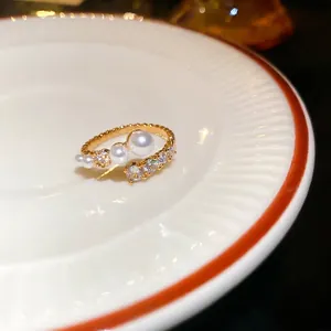Elegant gold plated open ring with white pearls and sparkling cubic zirconia stones