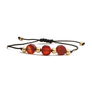 Handmade braided rope bracelet with natural red agate beads and golden accents