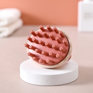 Pink silicone scalp massage hair brush with ergonomic handle for shampooing in a bathroom