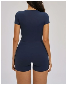 Rear view of tight-fitting dark blue yoga set showing slim-cut short sleeve and high waist shorts