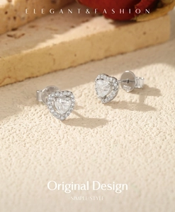 Detailed close-up of S925 sterling silver heart studs with shimmering moissanite