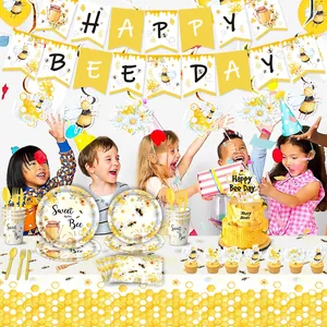 Bee-themed kids birthday party set with plates napkins and happy bee day banner
