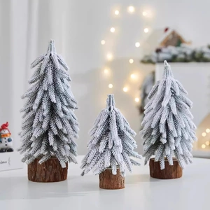 Three-piece set of mini flocked PE Christmas trees with wooden bases and snowy finish