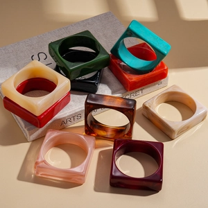 Exaggerated colorful acrylic square bangles in marble and tortoiseshell patterns