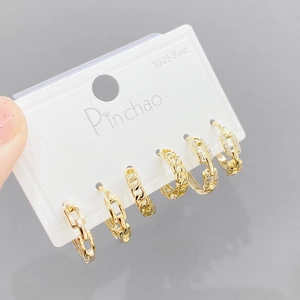 Close-up of gold S925 silver post earring set featuring Cuban chain and zircon details